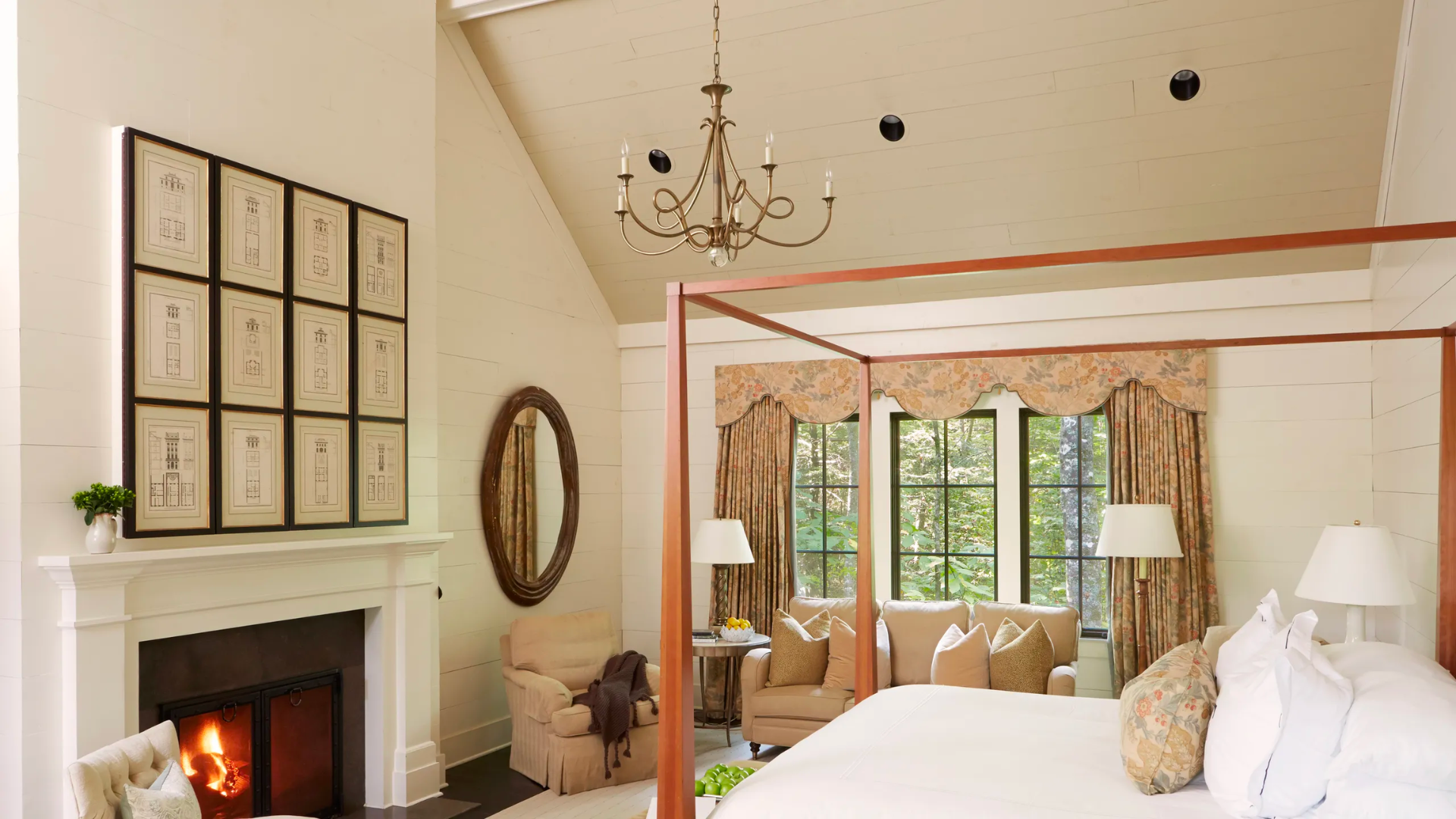 Luxury retreat bedroom with fireplace and four poster bed.